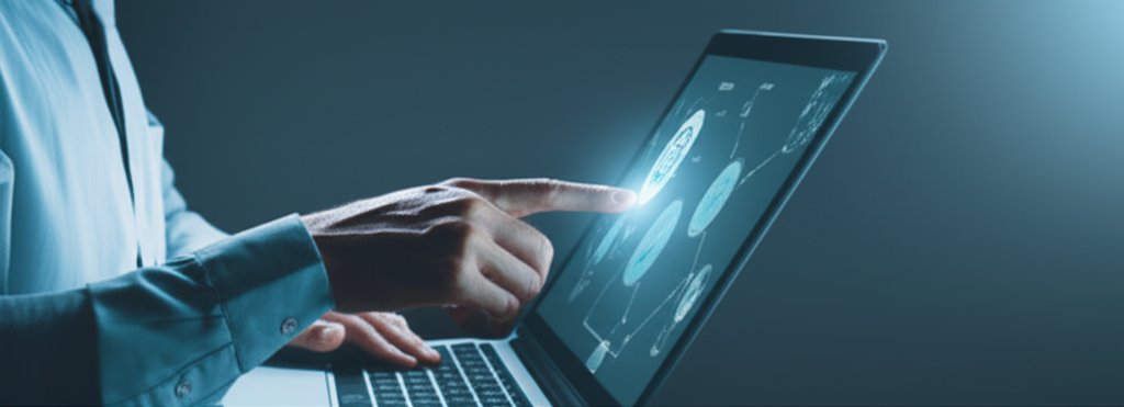 Diverse professional uses a modern laptop for secure passwordless authentication. Their hand implies biometric login; scre...